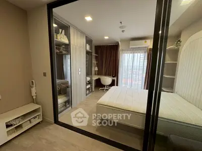 Modern bedroom with glass partition, cozy study nook, and ample storage space.