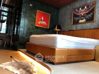 Luxurious bedroom with leather bed frame and elegant wall art