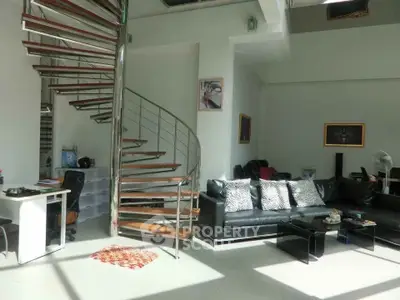 Modern living room with spiral staircase and stylish decor