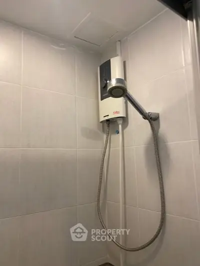 Modern bathroom with sleek shower unit and tiled walls, perfect for a contemporary home.