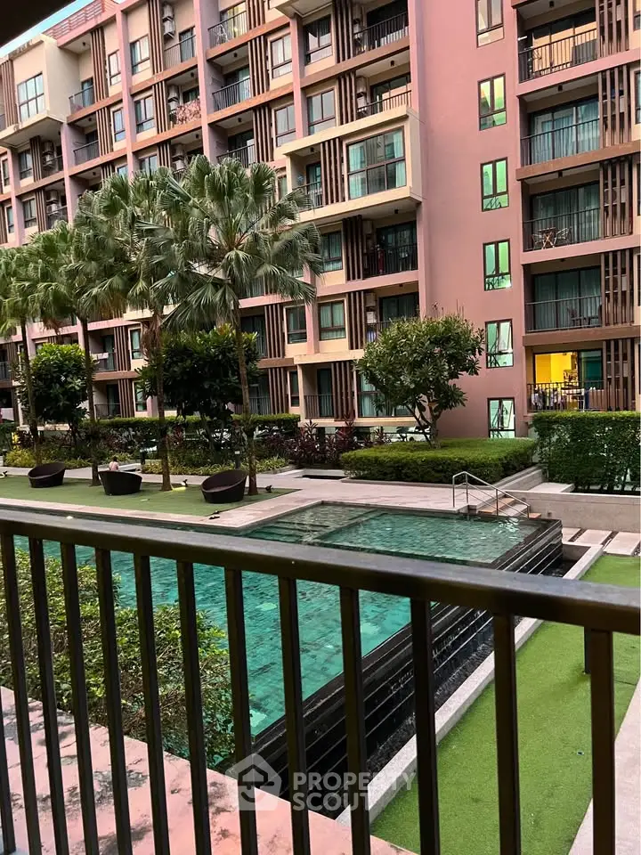 Modern apartment complex with pool and lush greenery, perfect for urban living.