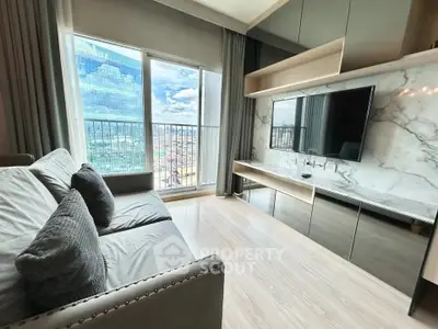 Modern living room with large windows and city view, featuring sleek furniture and a mounted TV.