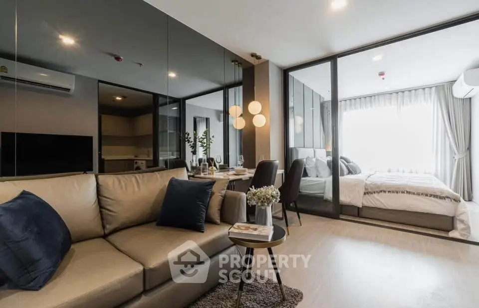 Modern open-plan living room with cozy sofa and stylish bedroom view