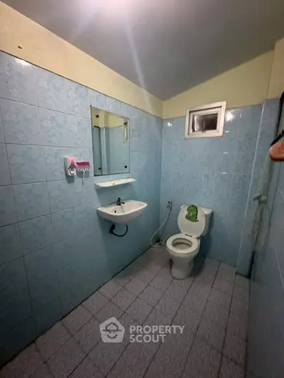 Spacious bathroom with blue tiles and modern fixtures
