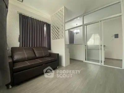 Modern living room with glass partition and stylish decor