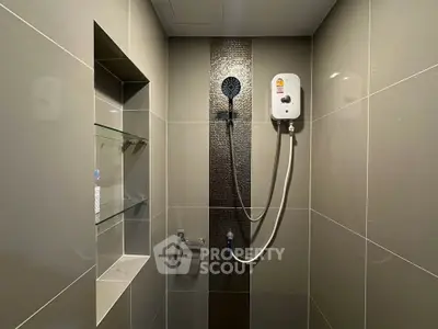 Modern bathroom shower area with sleek tiles and built-in shelving