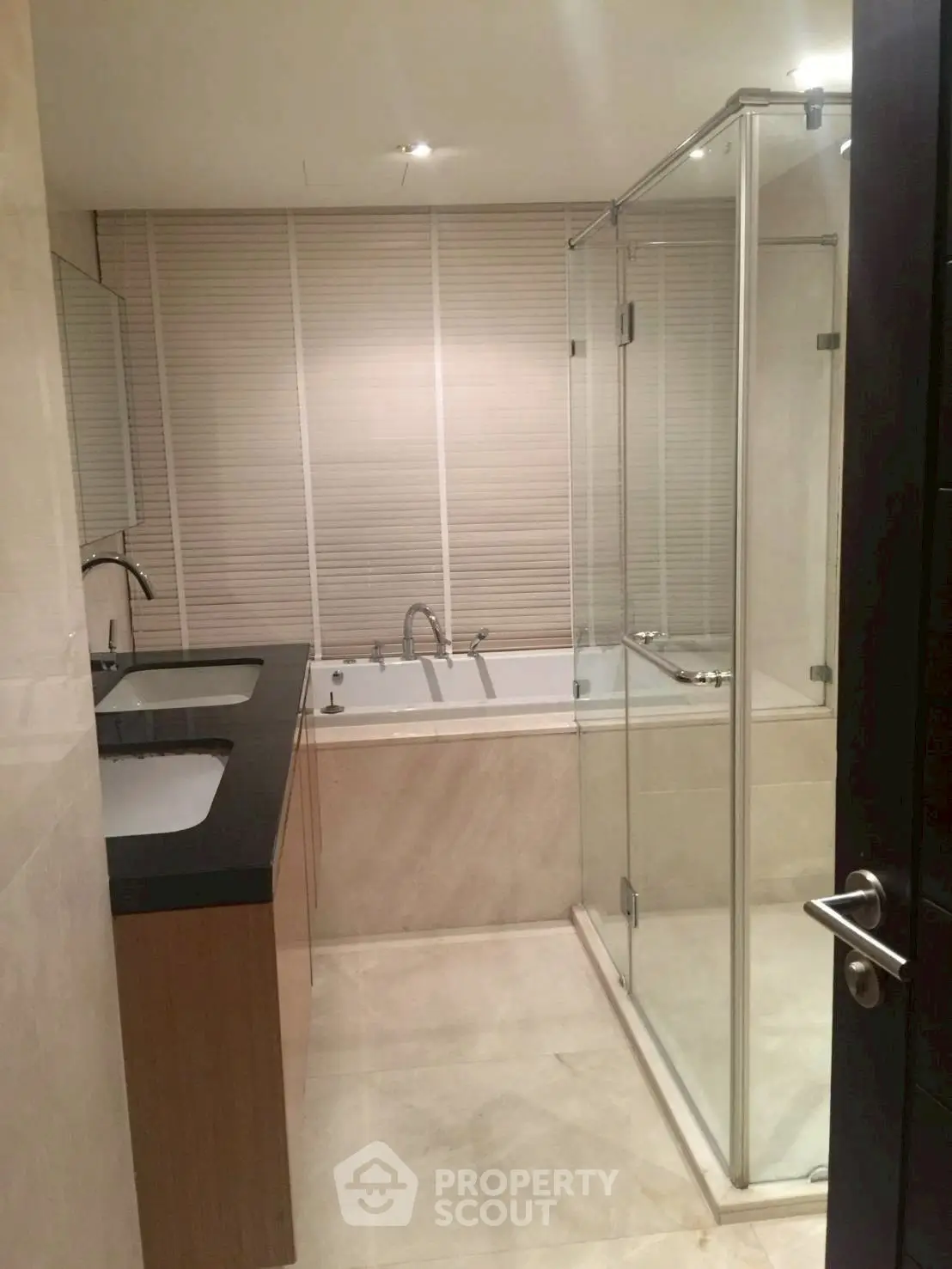 Luxurious bathroom with dual sinks and glass shower enclosure