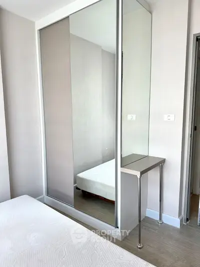 Modern bedroom with mirrored closet and minimalist decor