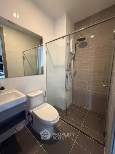 Modern bathroom with glass shower enclosure and sleek fixtures