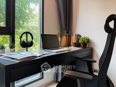 Modern home office with sleek desk, laptop, and large window view, perfect for productivity and inspiration.