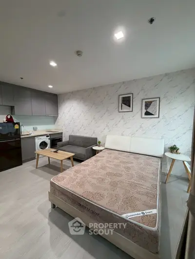 Modern studio apartment with stylish decor and compact kitchen