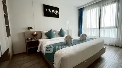 Modern bedroom with elegant decor and large window for natural light