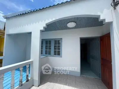 Charming exterior view of a cozy home with inviting balcony and classic architectural details.