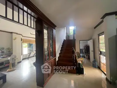 Spacious interior with wooden staircase and bright living area in a modern home.