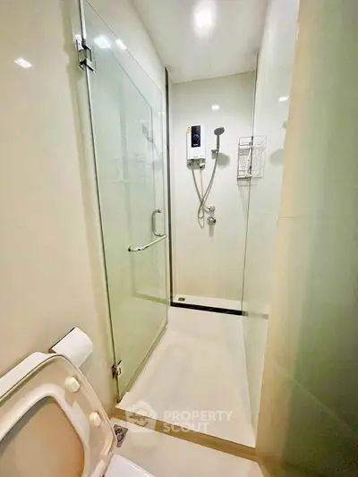 Modern bathroom with glass shower enclosure and sleek fixtures