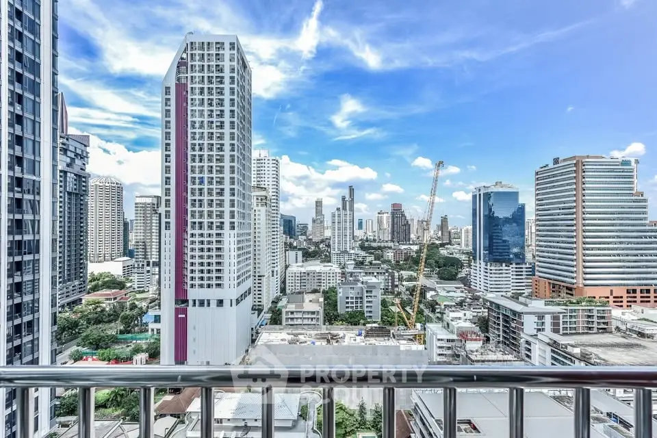 Stunning cityscape view from a high-rise balcony showcasing urban skyline and blue skies.