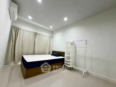 Modern minimalist bedroom with sleek design and ample natural light