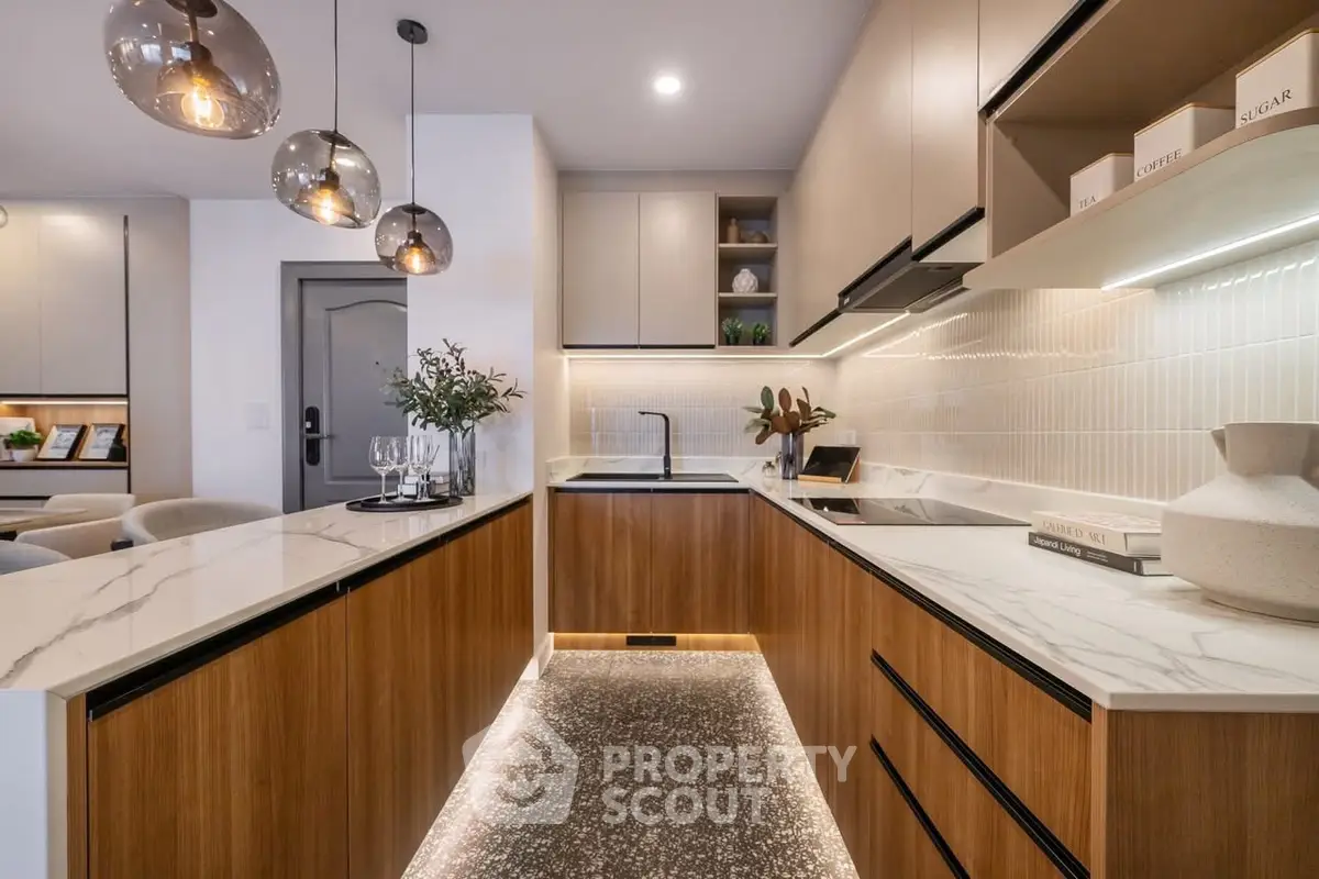 Modern kitchen with sleek design, marble countertops, and ambient lighting.