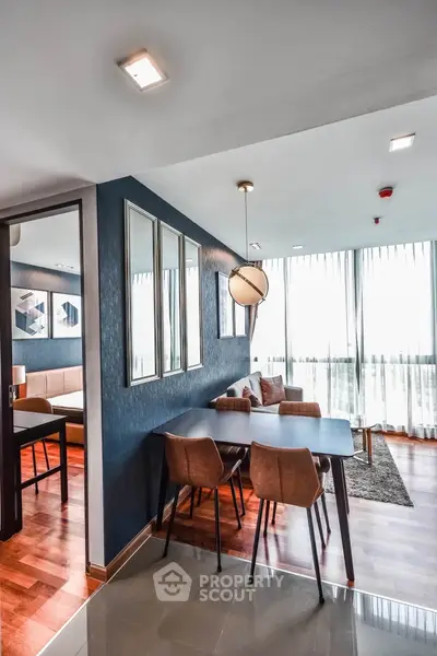 Modern dining area with stylish decor and natural light in a contemporary apartment.