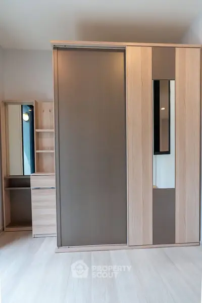 Modern bedroom with sleek wardrobe and vanity set, perfect for stylish storage solutions.
