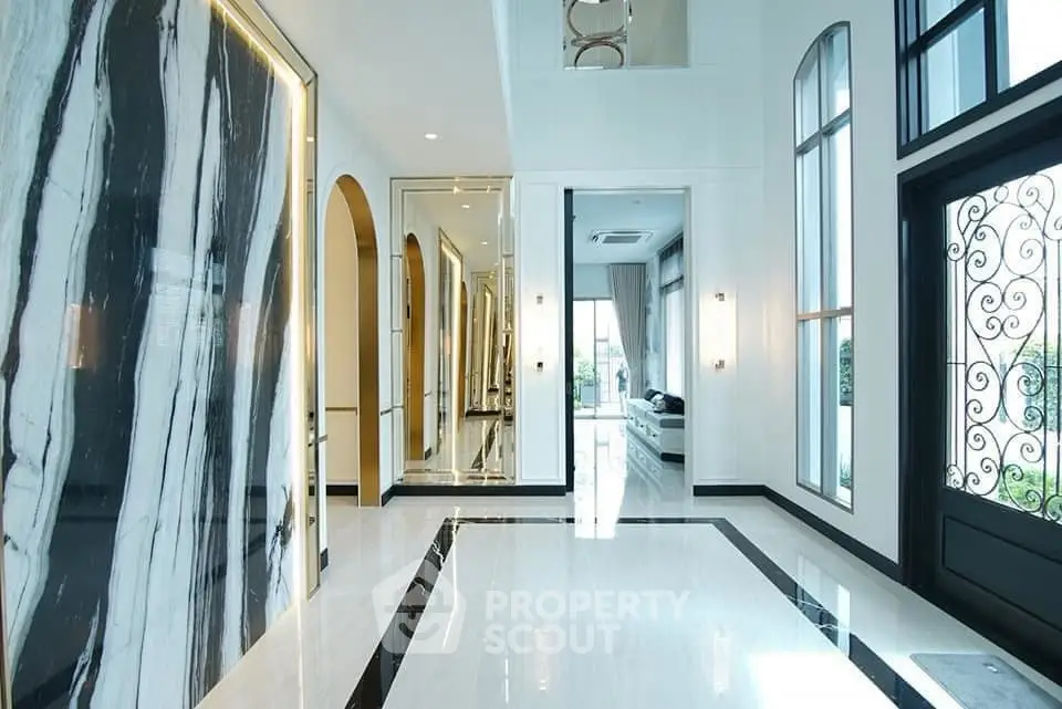 Luxurious modern entrance with high ceilings and elegant marble accents