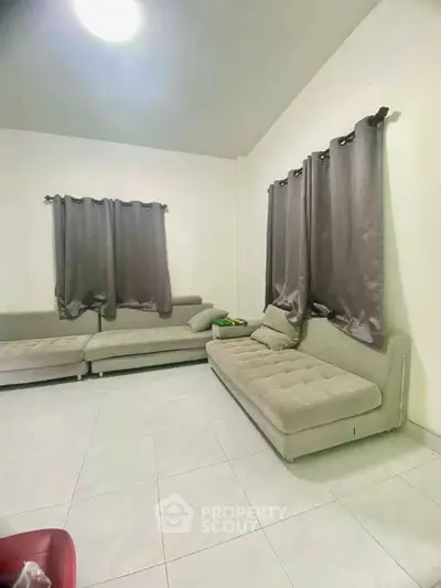 Spacious living room with modern sofas and tiled flooring