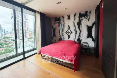 Luxurious bedroom with stunning city view and modern design in high-rise apartment.