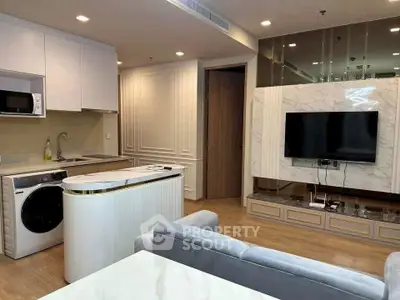 Modern open-layout living room with sleek kitchen and stylish marble TV wall.