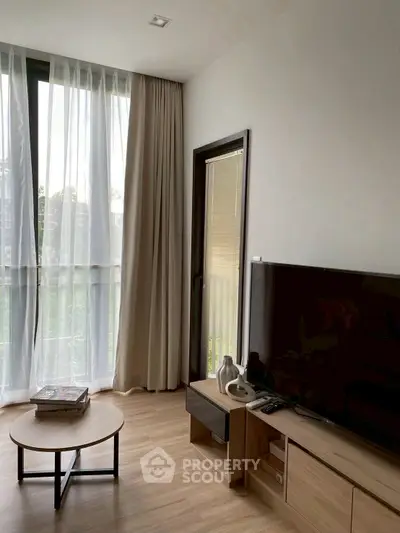 Modern living room with large window and stylish furniture