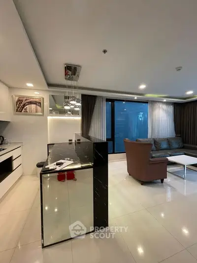 Modern open-layout living room with sleek kitchen and stylish decor