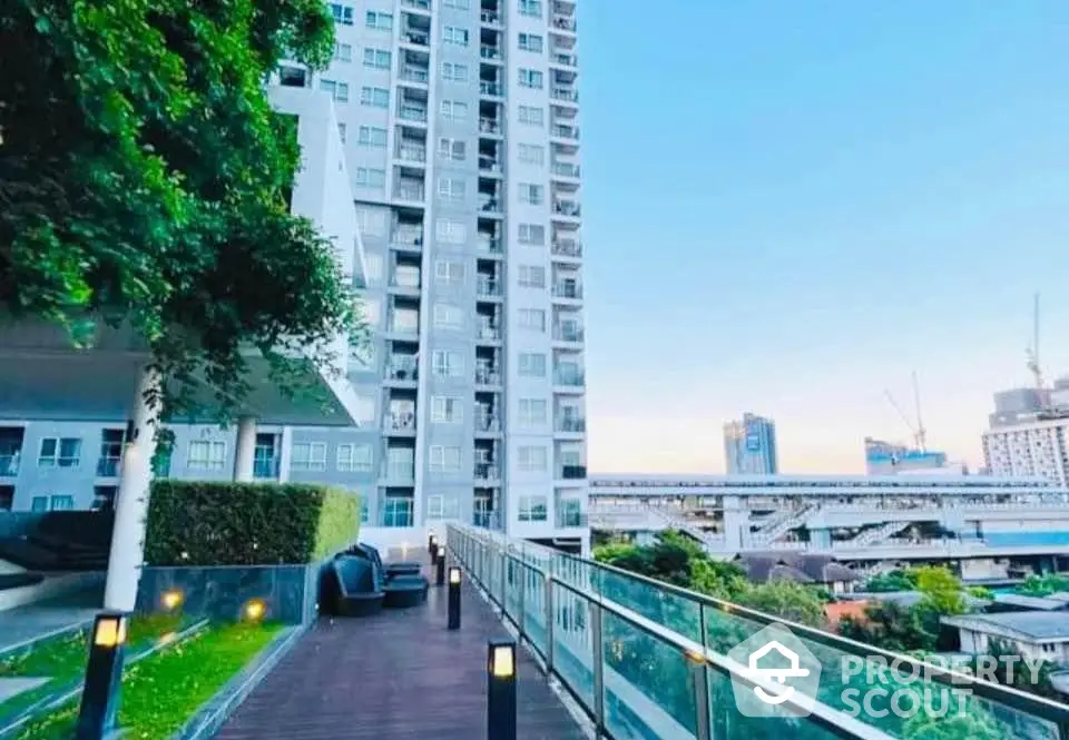 Modern high-rise building with spacious balcony and city view