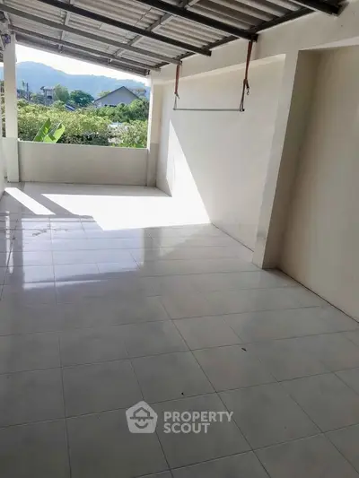 Spacious tiled balcony with scenic mountain view, perfect for relaxation and outdoor activities.