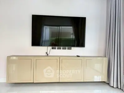 Modern living room with sleek TV setup and elegant cabinetry