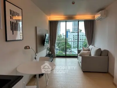 Modern living room with city view, cozy sofa, and stylish decor
