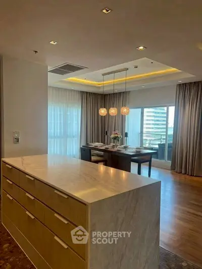 Luxurious open-layout kitchen with elegant dining area and city view