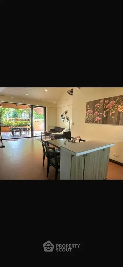 Spacious living room with open layout and large balcony access, perfect for entertaining.