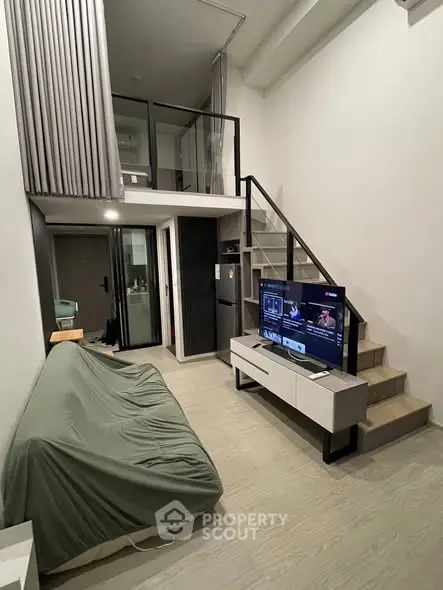 Modern loft-style living room with mezzanine and sleek furniture