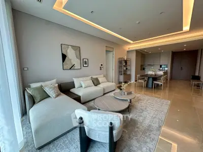 Luxurious modern living room with elegant furniture and open kitchen layout