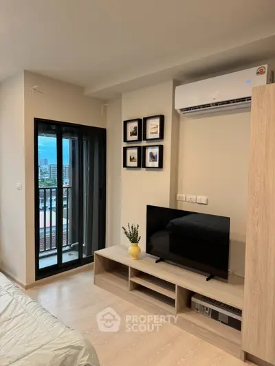 Modern bedroom with balcony access and sleek air conditioning unit