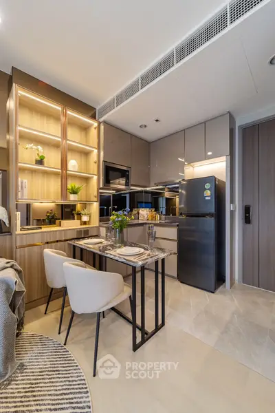 Modern kitchen with sleek cabinetry and dining area in luxury apartment