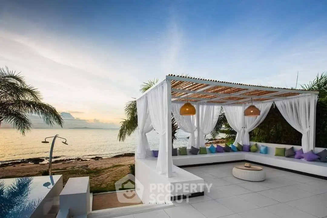 Luxurious beachfront patio with stunning ocean view and elegant seating area.