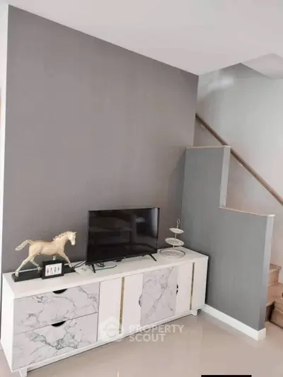 Modern living room with stylish TV stand and decorative horse statue