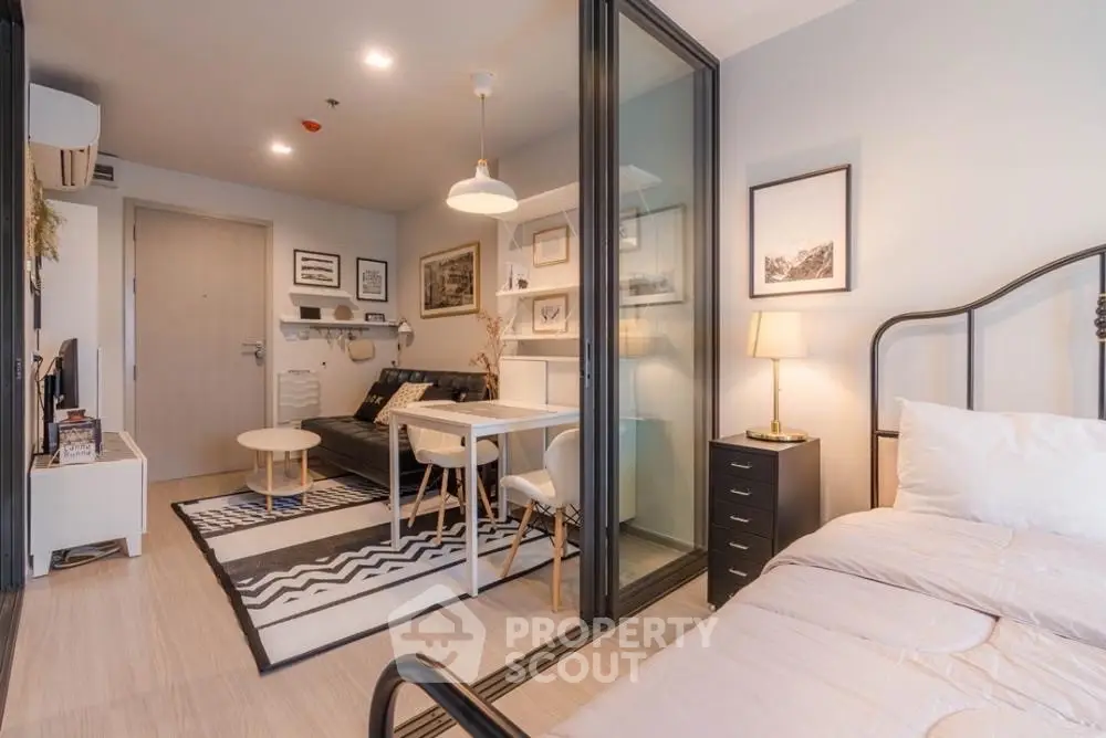 Modern studio apartment with stylish decor and open layout, featuring a cozy living area and comfortable bedroom.