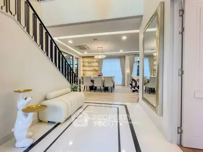 Luxurious open-plan living and dining area with elegant decor and modern furnishings.