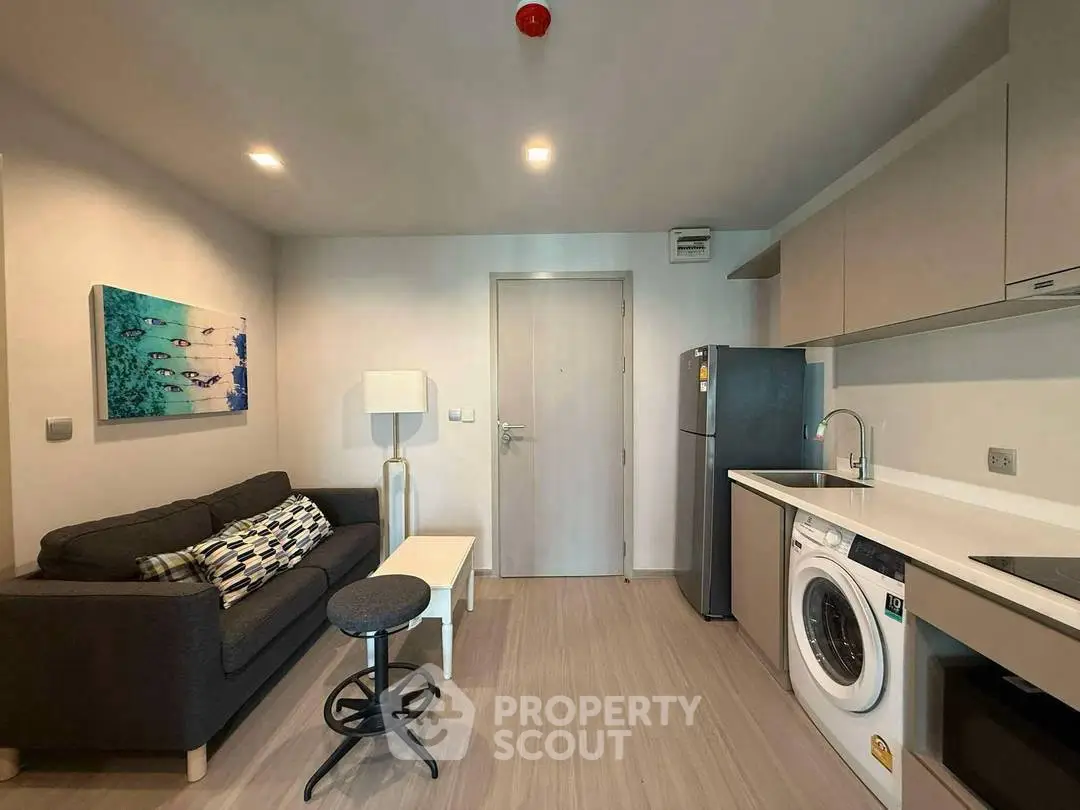 Modern compact living room with integrated kitchen and washing machine