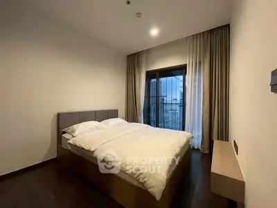 Modern bedroom with cozy double bed and balcony view