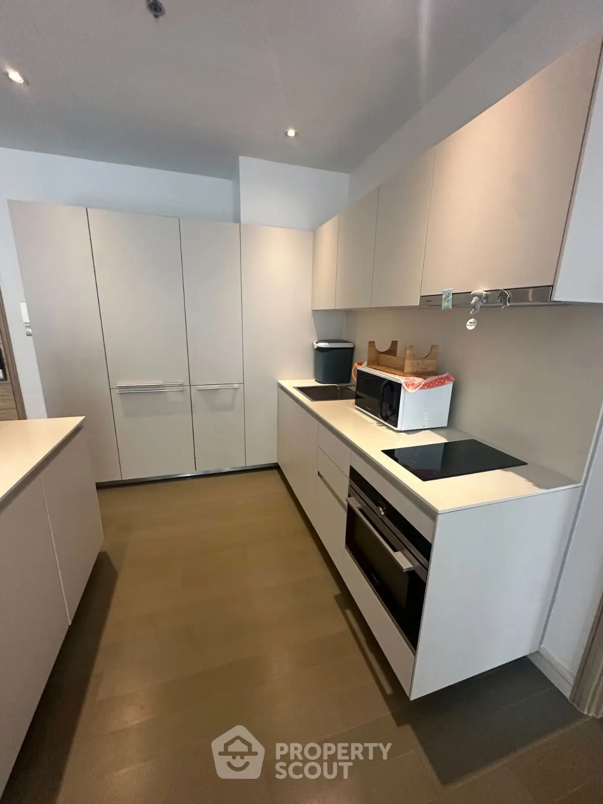 Modern kitchen with sleek cabinetry and built-in appliances in a contemporary apartment.