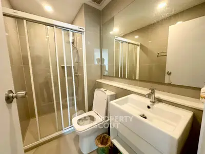 Modern bathroom with sleek fixtures and glass shower enclosure