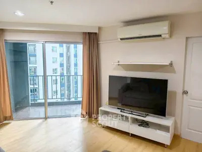 Modern living room with balcony and air conditioning in urban apartment.