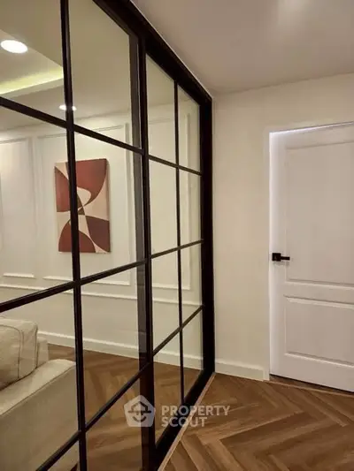Modern interior with glass partition and stylish wooden flooring